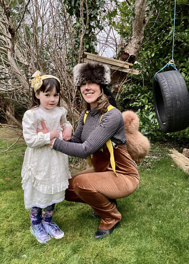 Woman dressed as squirrel with a child